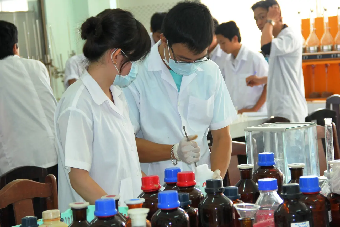 Biotechnology students working together at a laboratory bench